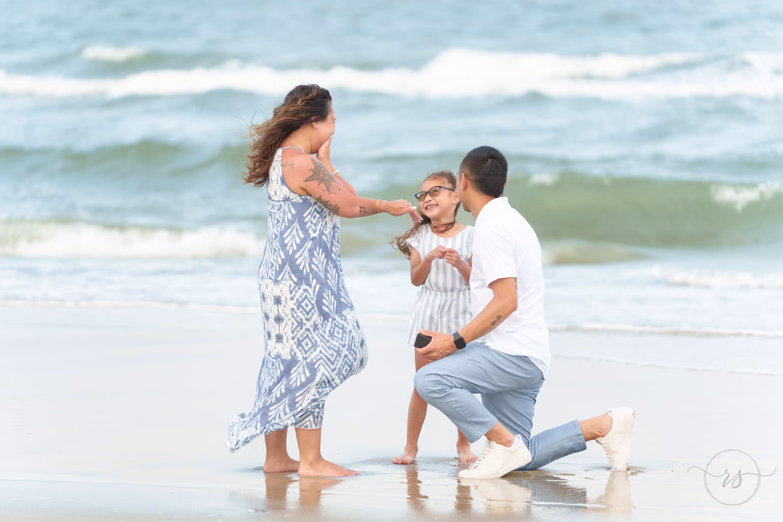 Showing the ring to her daughter after the surprise proposal - Huntington Beach State Park