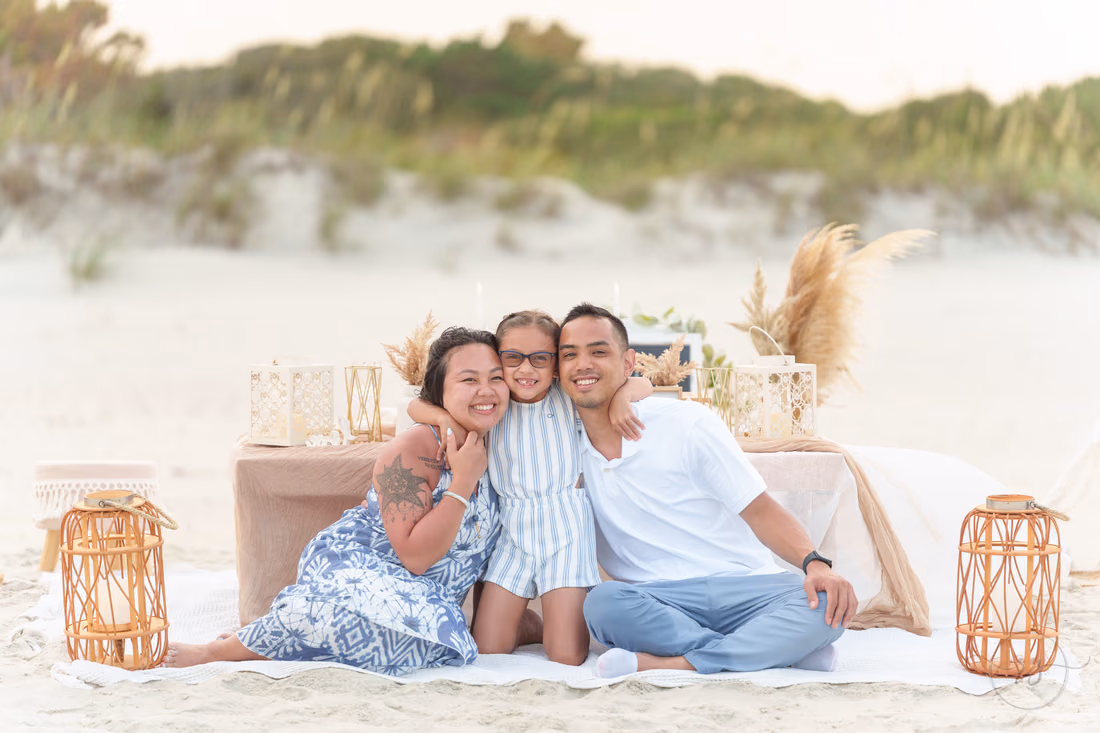 Family smiling on the picnic blanket by the dunes - Huntington Beach State Park