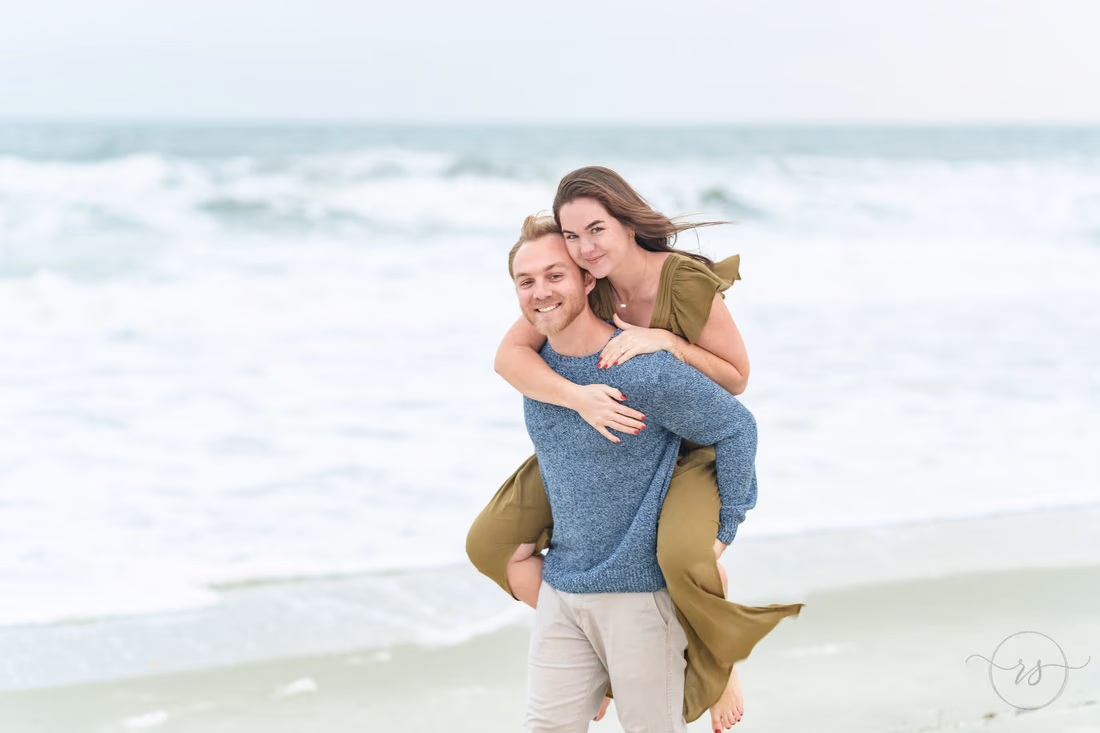Piggyback ride by the waves on a cloudy day - Huntington Beach State Park