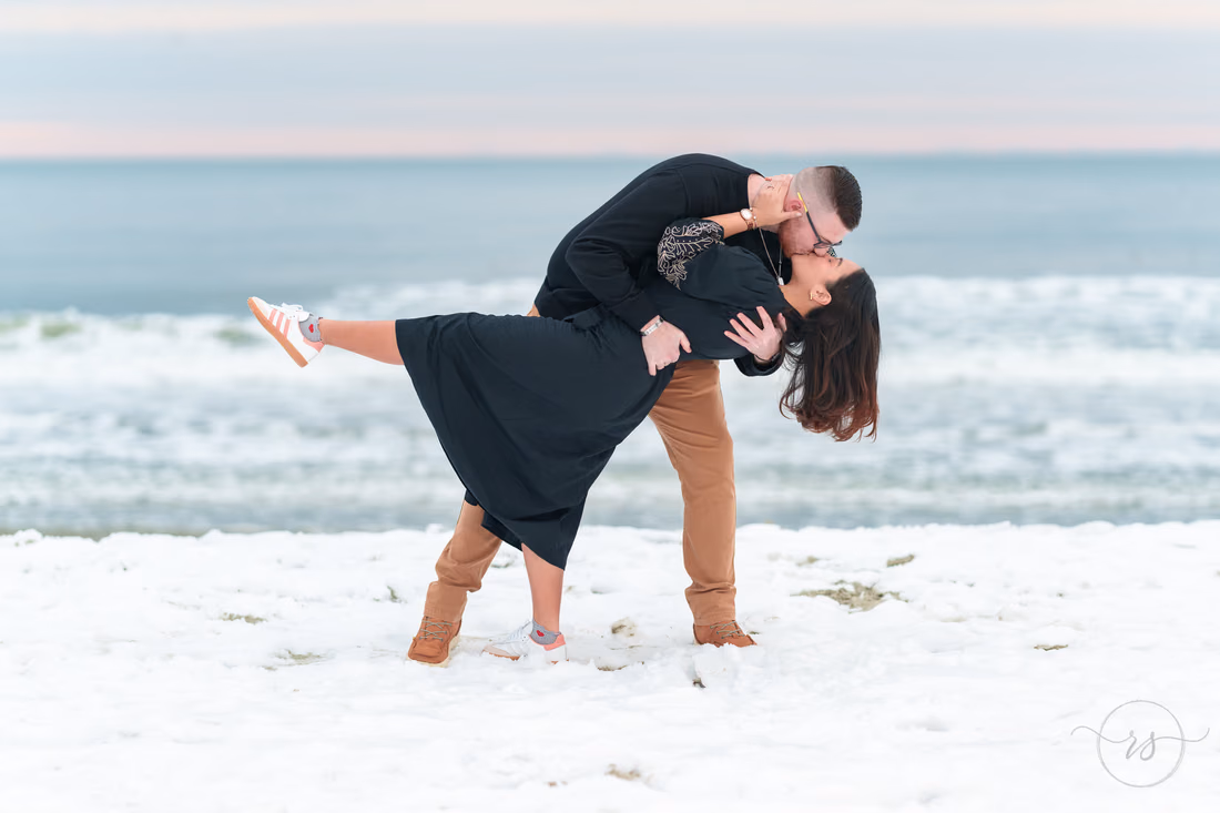 He dips her for a kiss on the snowy beach - Garden City Beach