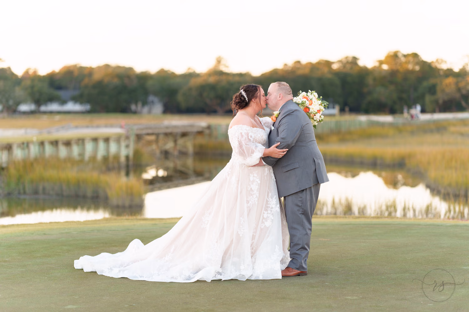Portraits of the bride and groom on the golf course overlooking the marsh - Pawleys Plantation
