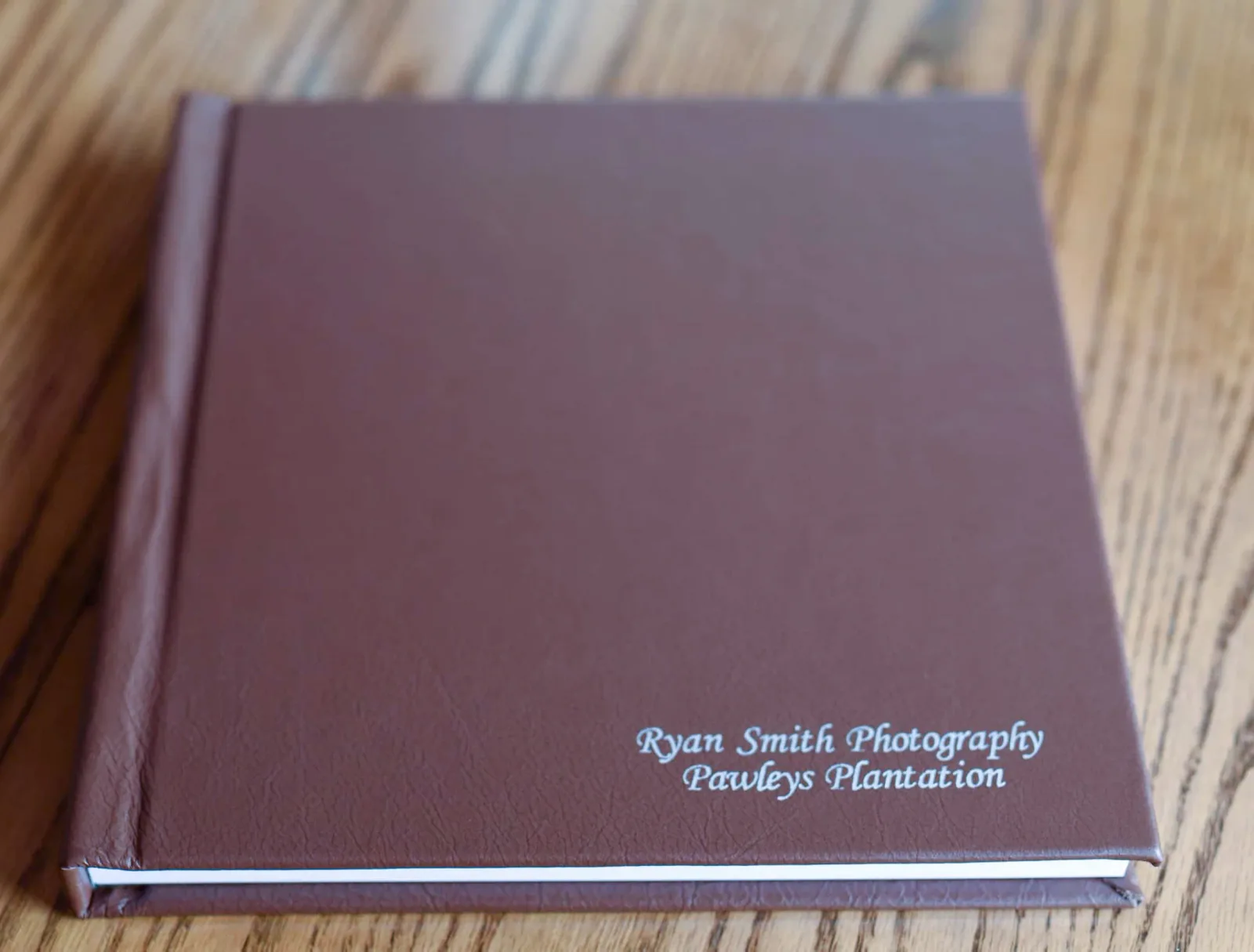 Standard wedding album with a brown leather cover and silver imprint