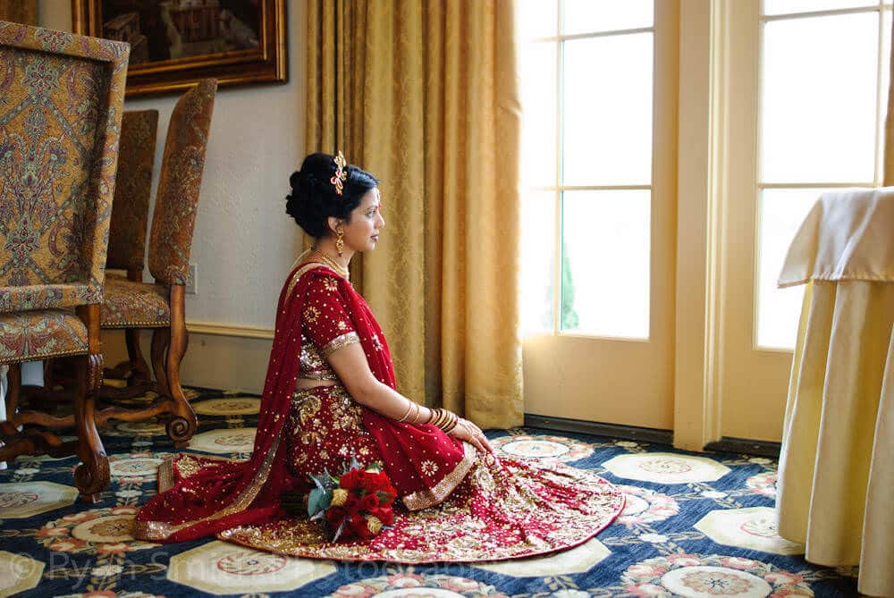 Indian bride with traditional dress sitting on floor