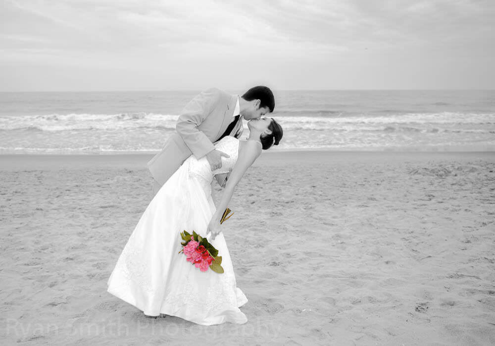 Black and white wedding portrait with color flowers
