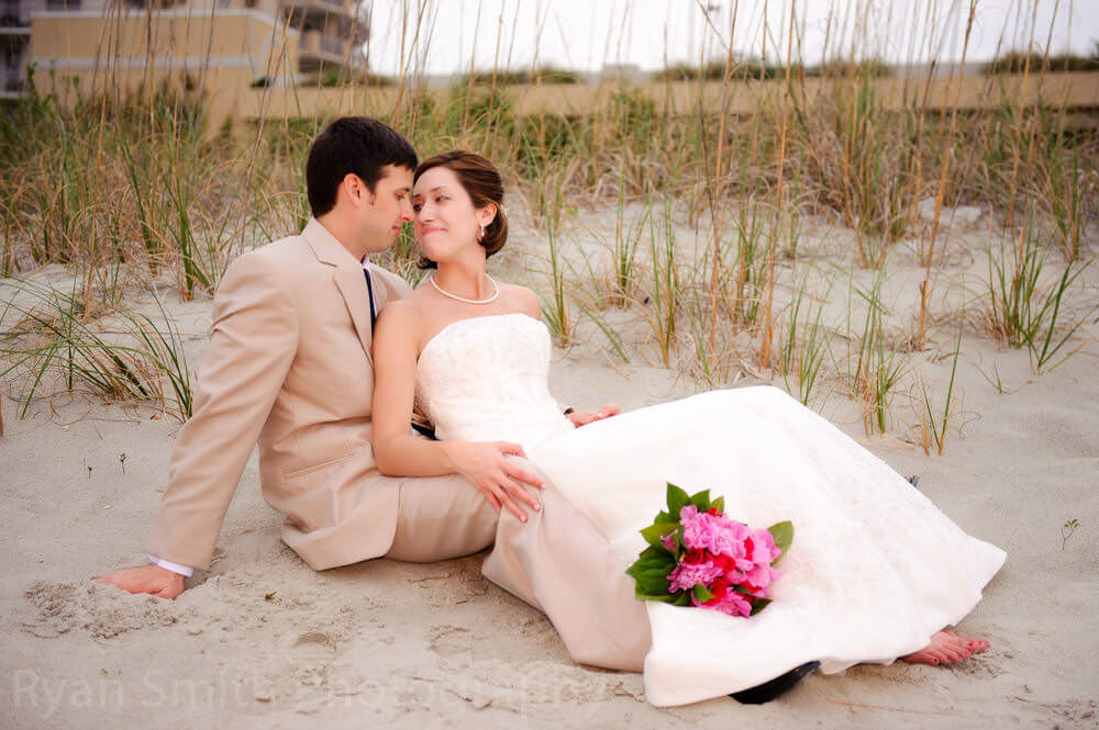 Bride and groom laying in the dunes, North Myrtle Beach