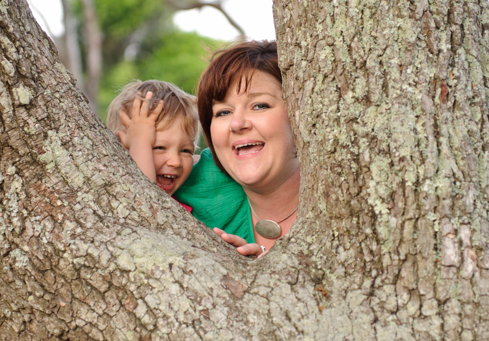Mom and son peeking through tree, Myrtle Beach State Park
