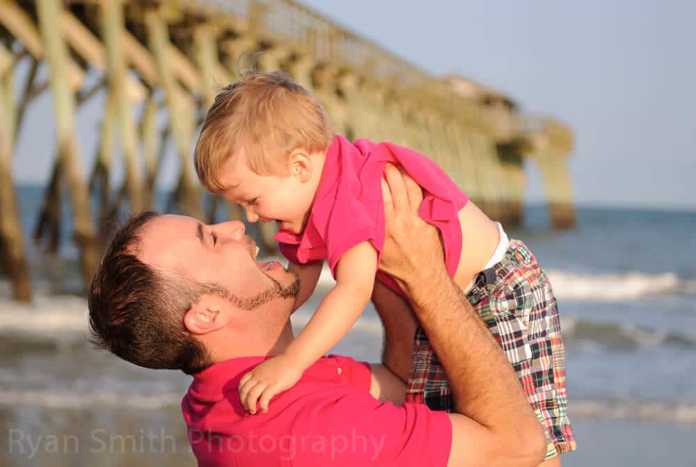 Father and little boy smiling at each other, Myrtle Beach State Park