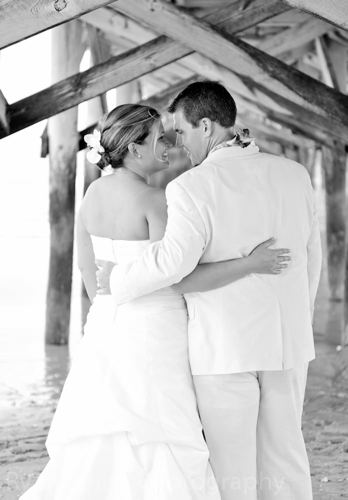 Bride and groom under the pier - Springmaid Beach