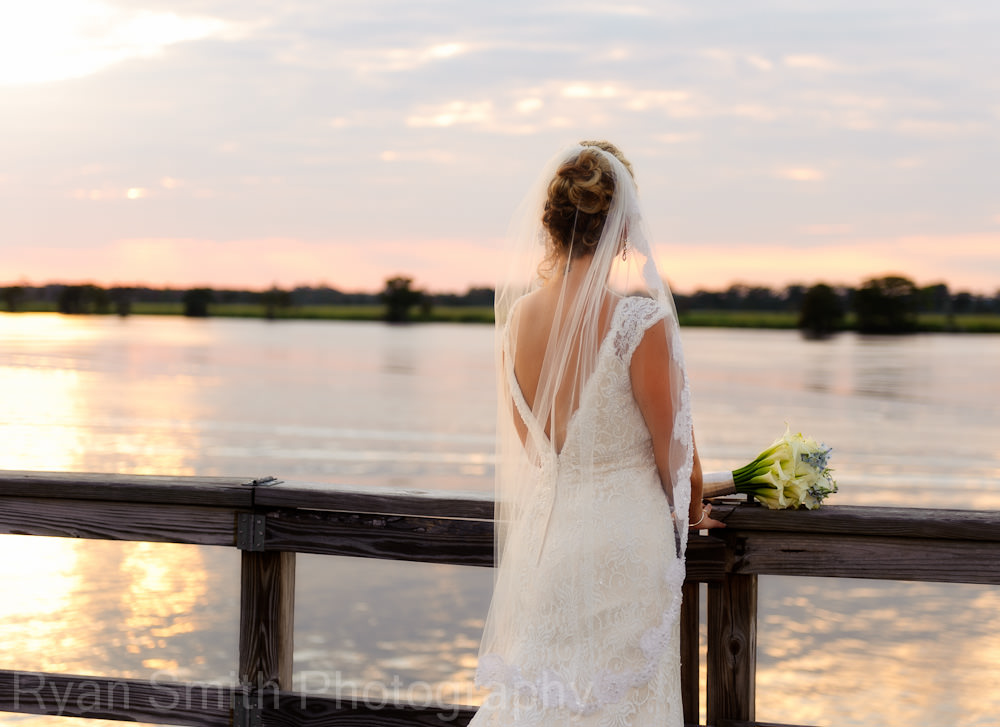 Bride looking at sunset on intracoastal waterway
