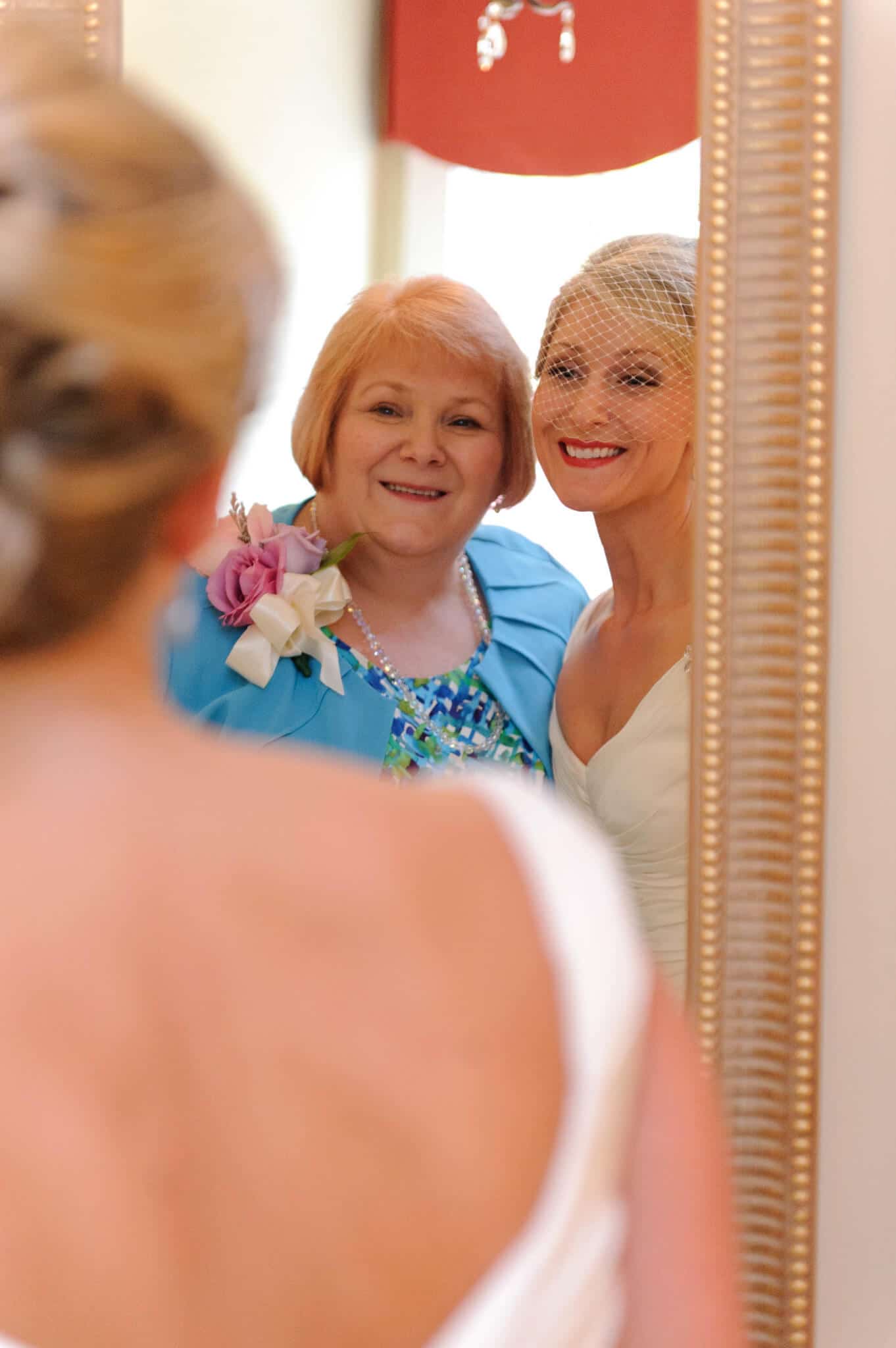 Bride and mom looking in mirror