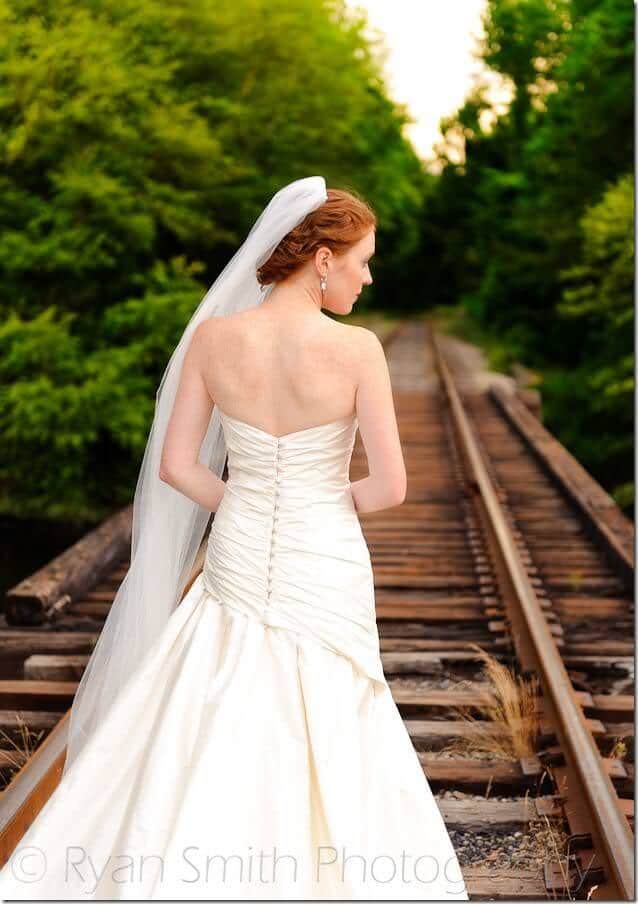 Bride walking down the train tracks - Conway River Walk