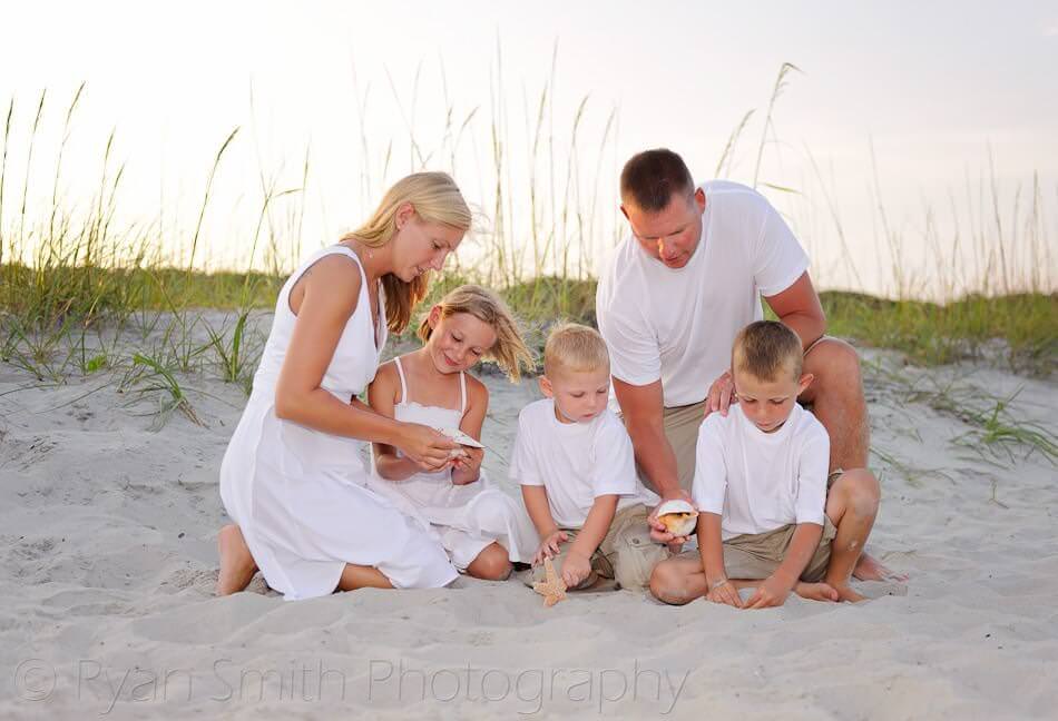 Family looking at sea shells together - Myrtle Beach State Park