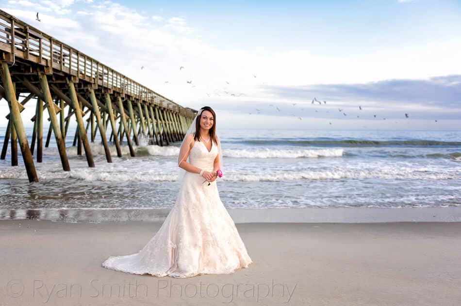 Bride standing in front of the pier