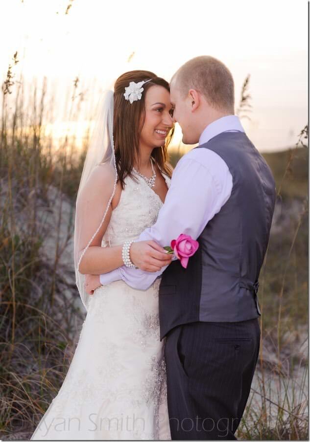 Couple leaning foreheads together in front of the sunset