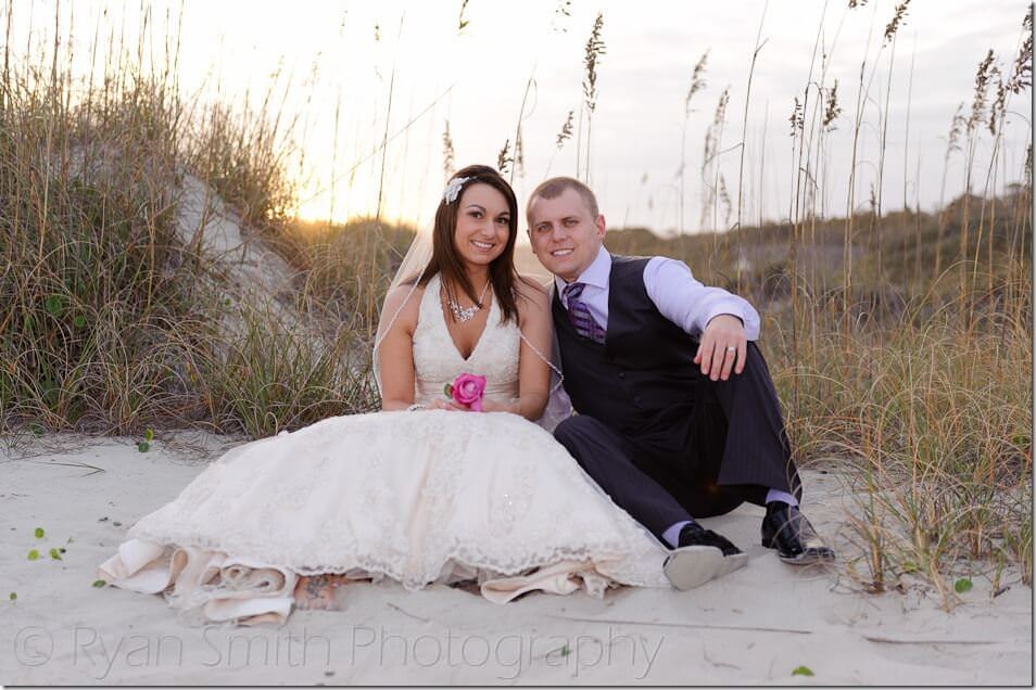 Couple sitting in front of the sunset - Myrtle Beach State Park