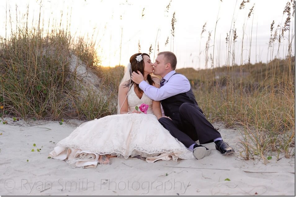 Couple sitting in front of the sunset - Myrtle Beach State Park