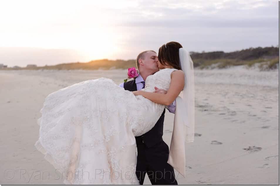 Groom lifting up bride for a kiss