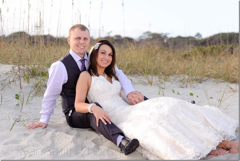 Couple laying in front of the dunes