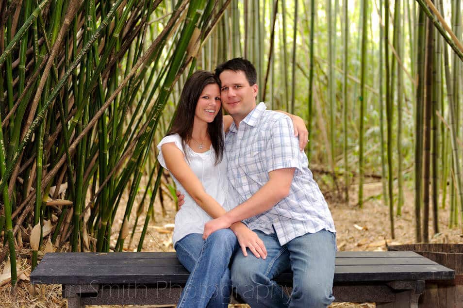 Couple sitting in the bamboo, you can see where people carve their names. - Magnolia Plantation Charleston 