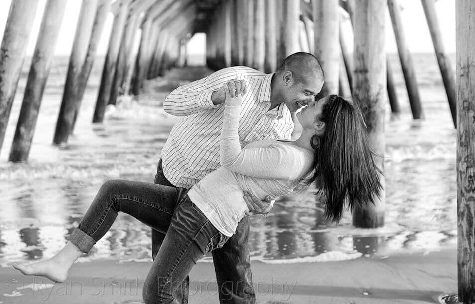 Couple having fun under the pier in black and white - Myrtle Beach State Park