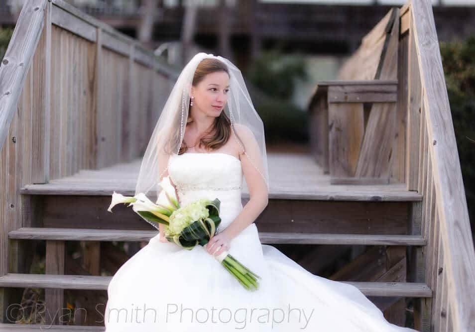 Bride sitting on steps with a bit of soft glow effect - Myrtle Beach