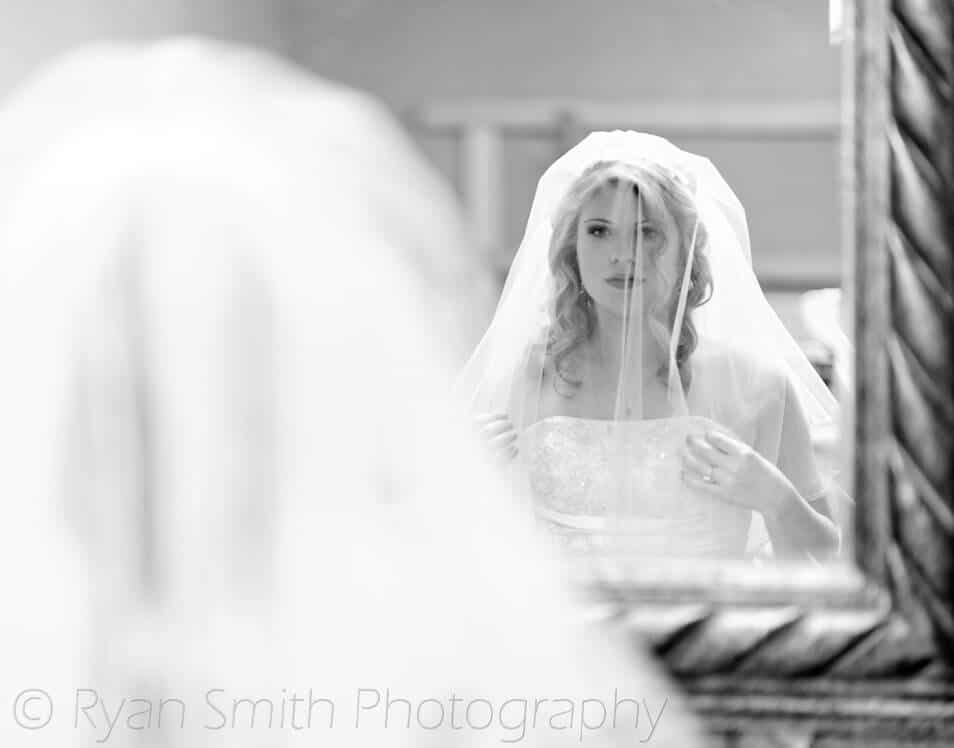 Bride making a last minute check in the mirror -
