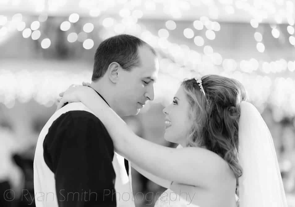 Bride and groom dancing with pretty bokeh from the lights -