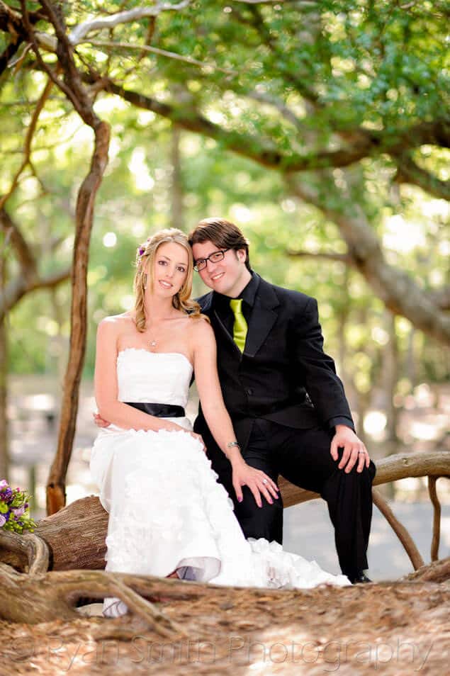 Bride and groom sitting in pretty light from the trees - Myrtle Beach State Park