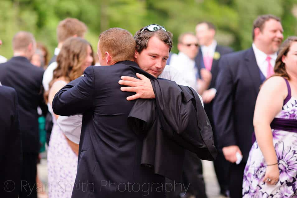 Groom getting a hug after the ceremony - Conway River Walk