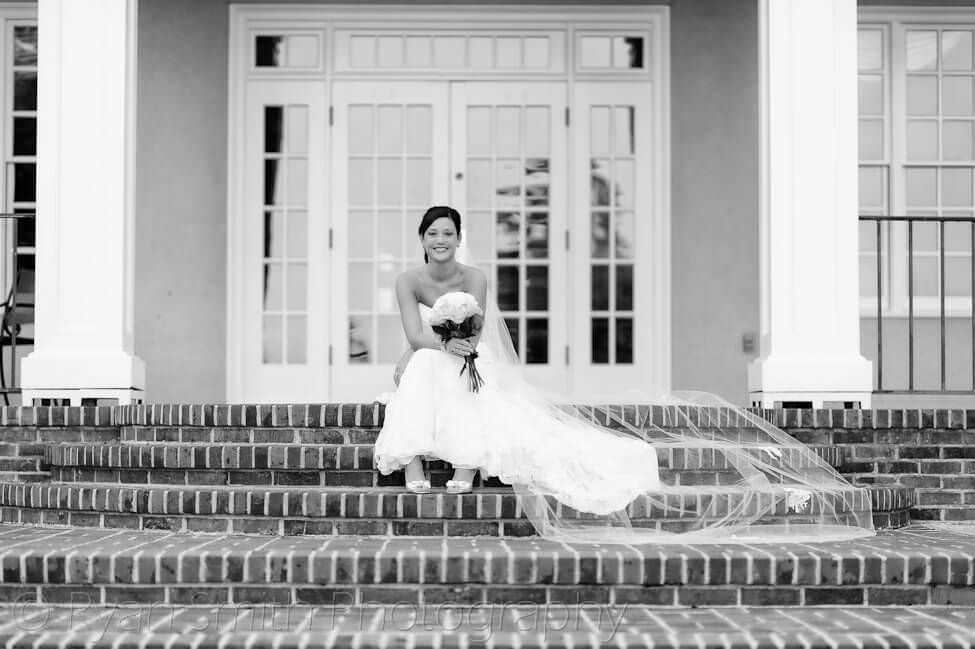 Bride sitting on the clubhouse steps -Pawley's Plantation