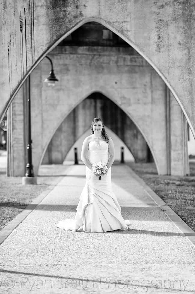 Bride under the old bridge into Conway, high structure black and white -