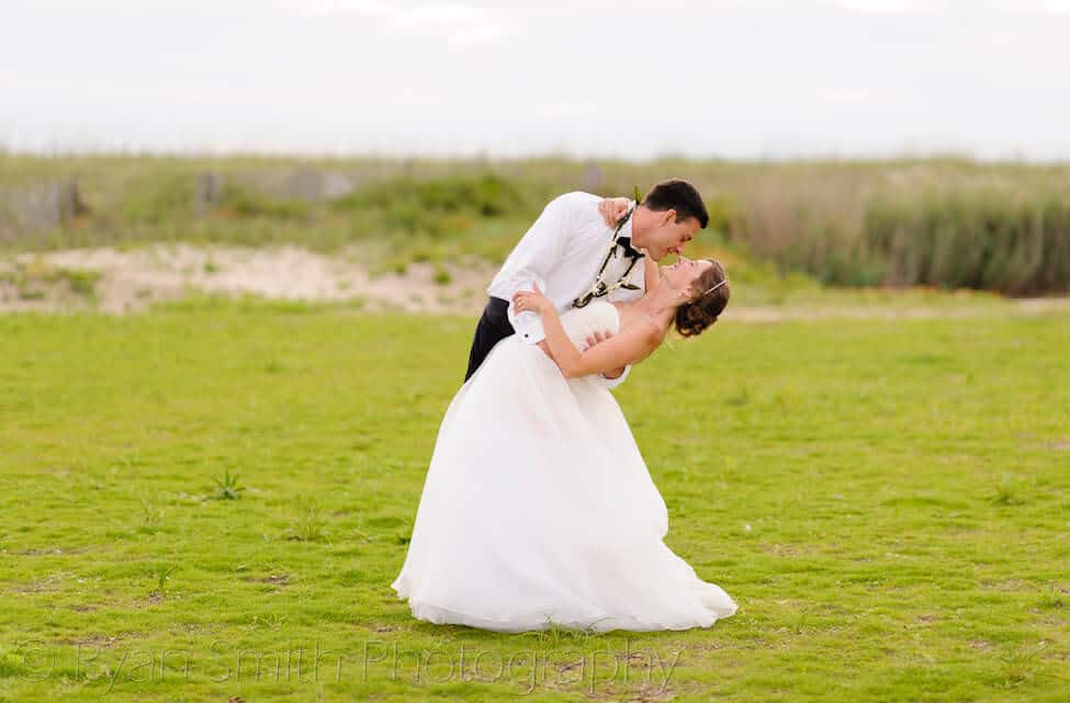 Bride and groom in a meadow - Bald Head Island