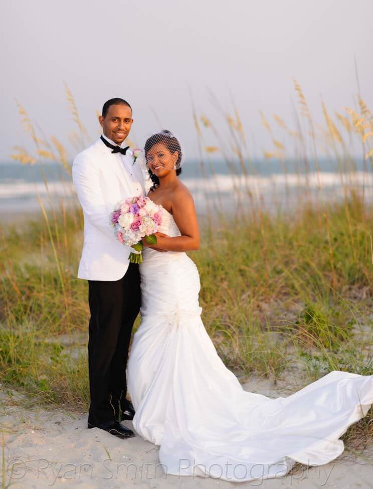 Bride and groom in front of the ocean