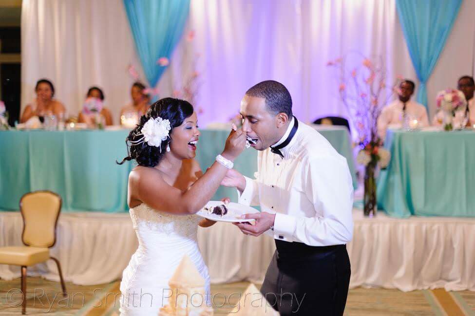 Feeding each other wedding cake