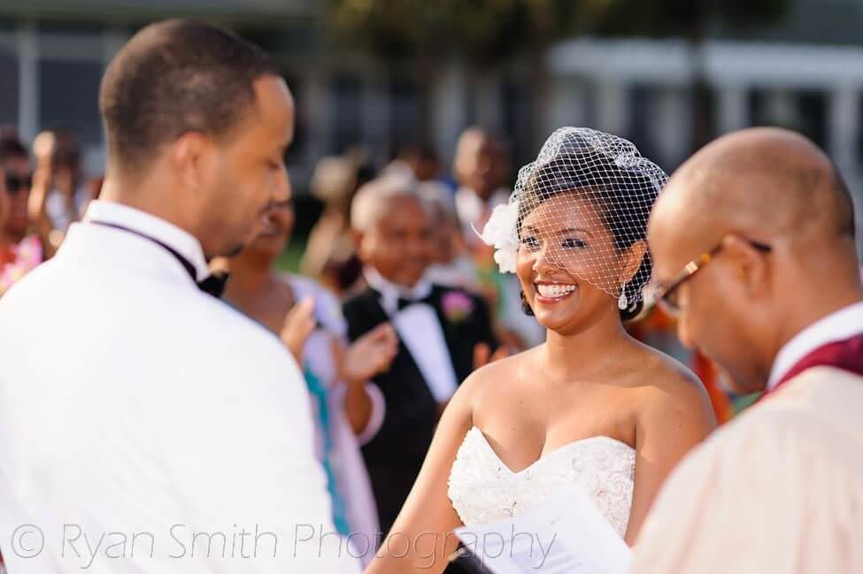 Happy bride looking at groom during ceremony