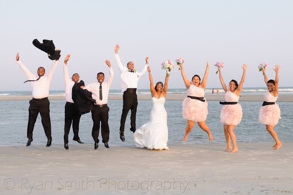 Wedding party jumping into the air