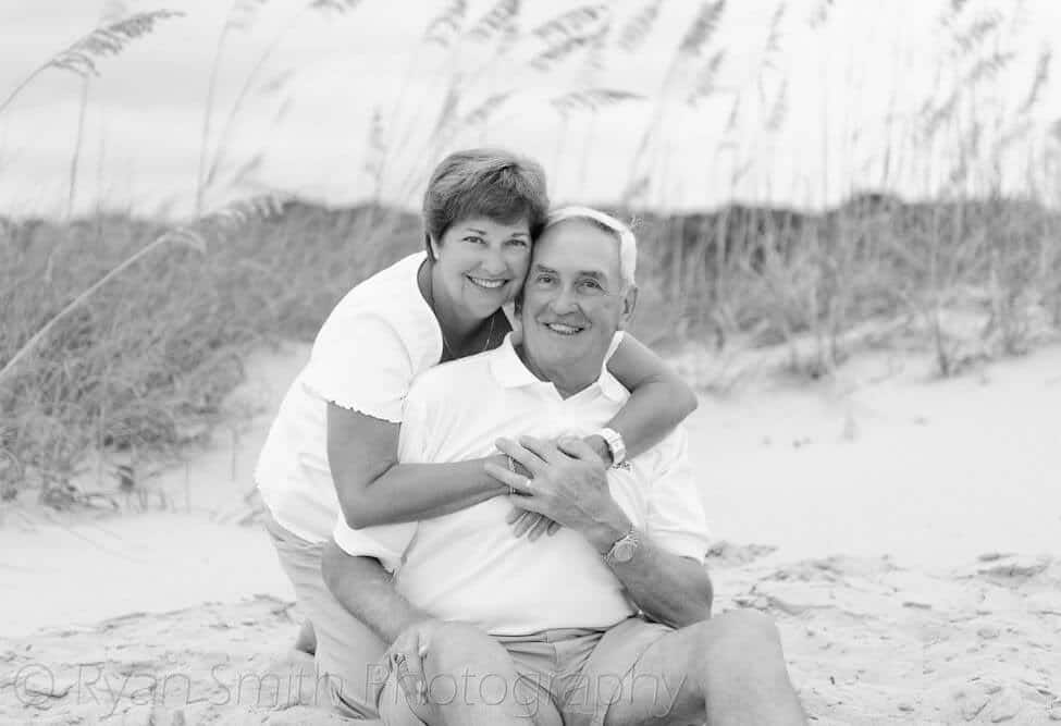 Couple smiling in front of the dunes - Myrtle Beach State Park