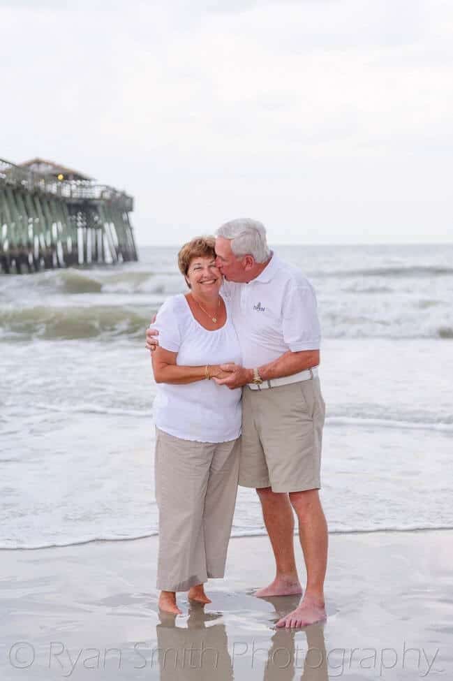 Older couple in front of pier - Myrtle Beach State Park