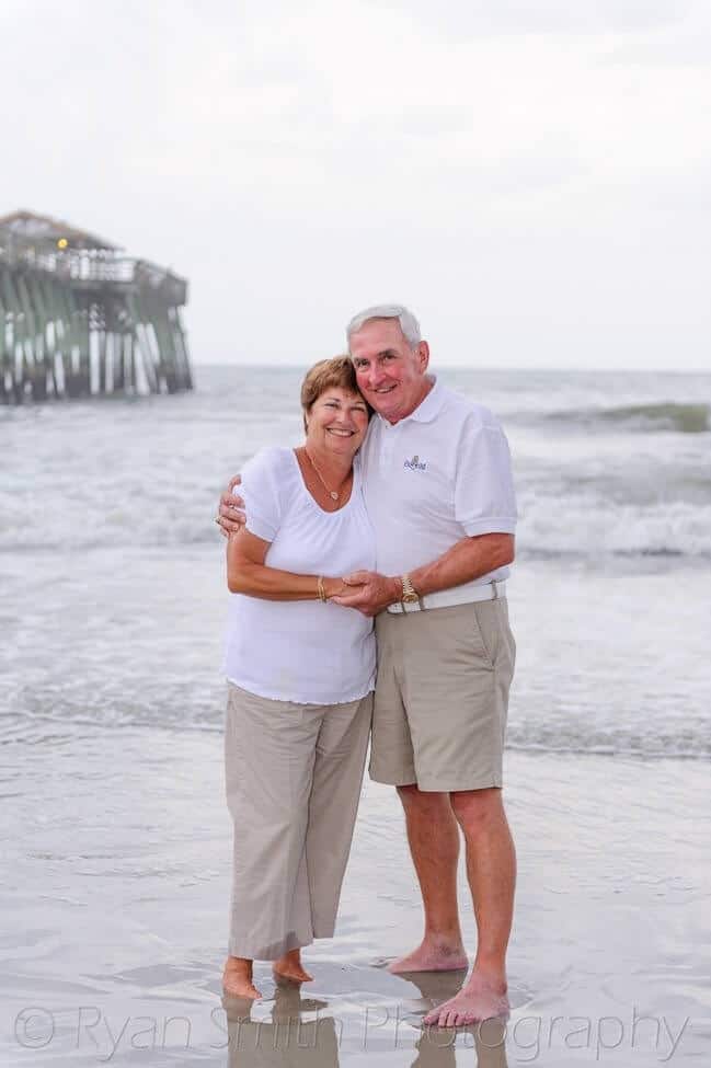 Older couple in front of pier - Myrtle Beach State Park