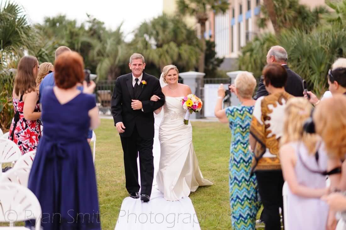 Bride and father walking down the isle - Caravelle Resort