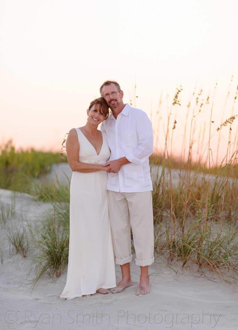 Couple standing in front of the sea oats - Holden Beach, NC