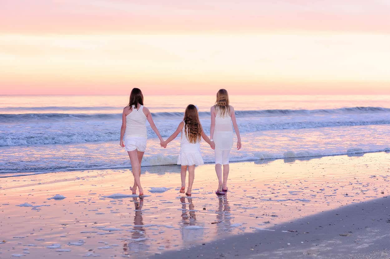 Sisters walking together in beautiful sunset
