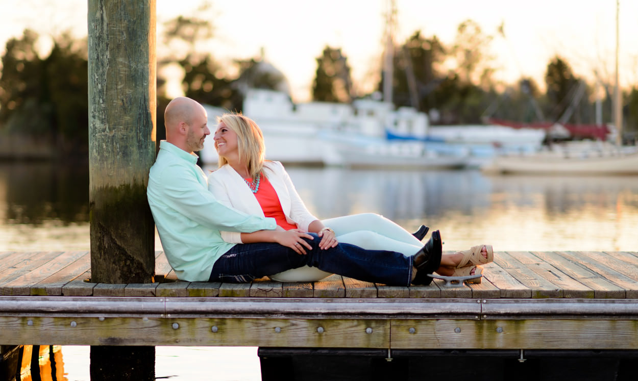 Couple leaning against a post at the Georgetown Harbor Walk