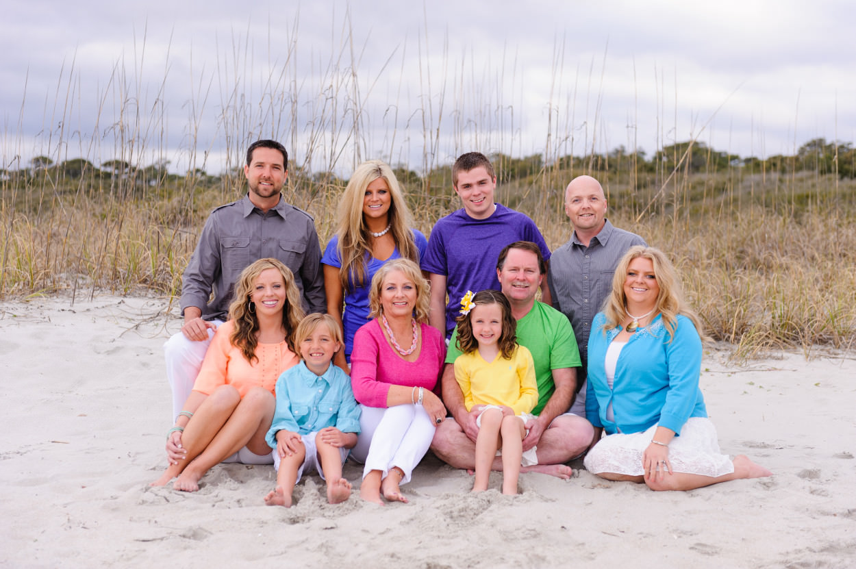 Portrait of large family with color shirts in front of the dunes in Myrtle Beach