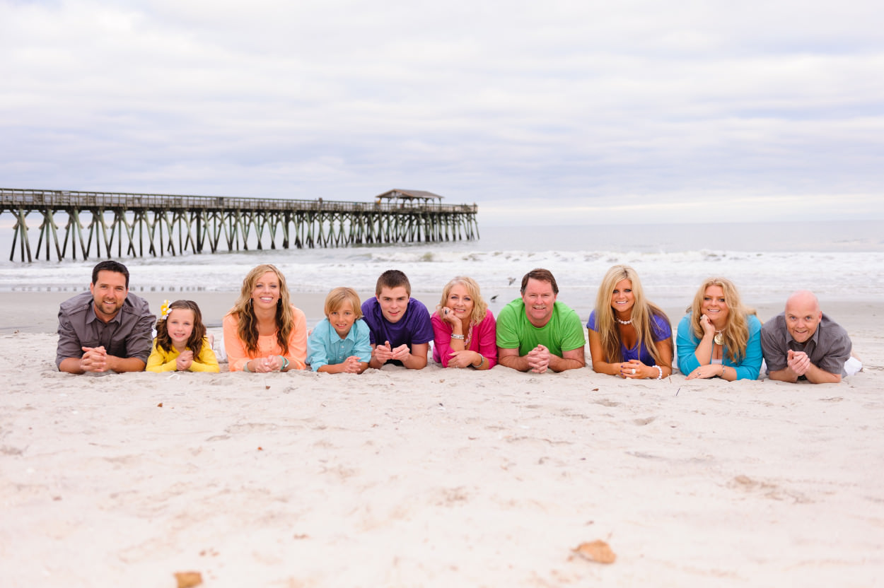 Large family laying in the sand together