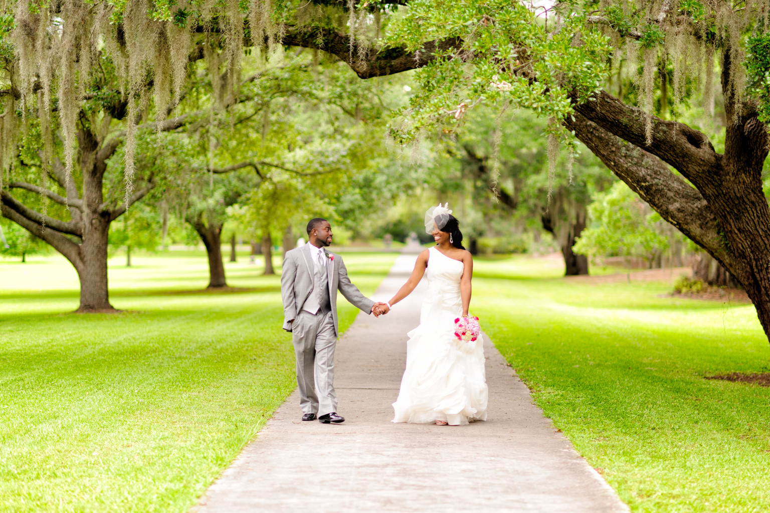 Bride and groom walking together in Brookgreen Gardens