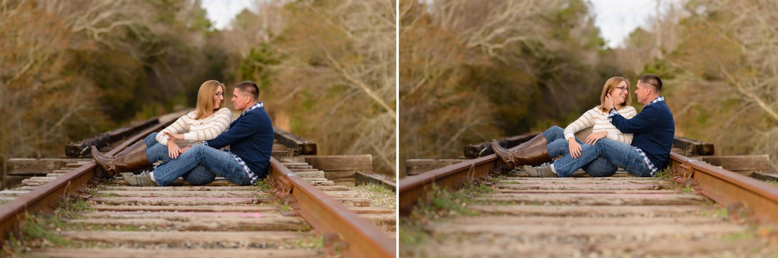 Couple sitting together on the old train tracks