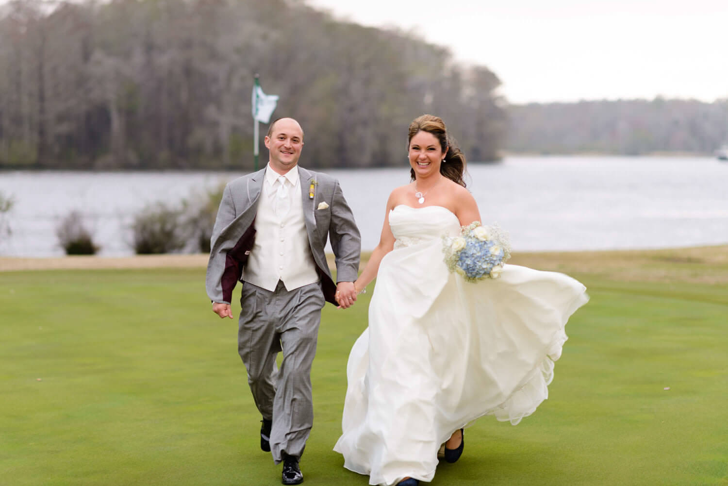 Cute picture of bride and groom running on golf course at Wachesaw Plantation