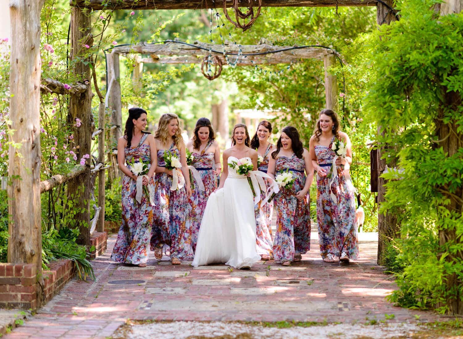 Bridesmaids having fun walking in gardens at The Ivy Place