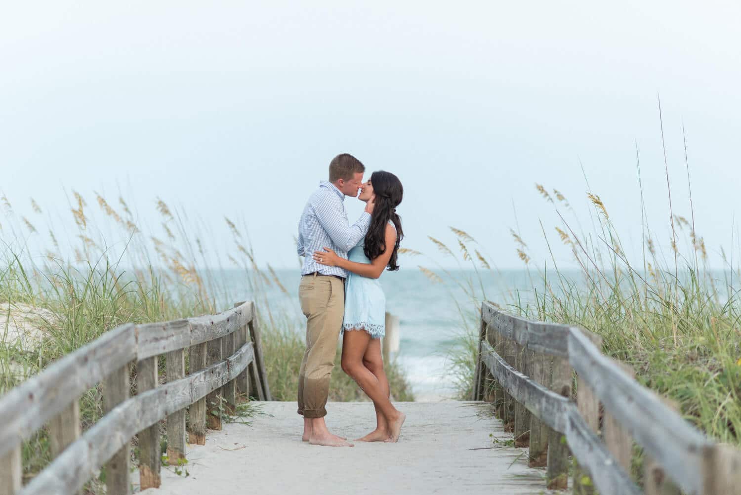 Kiss on a beach walkway by the sea oats